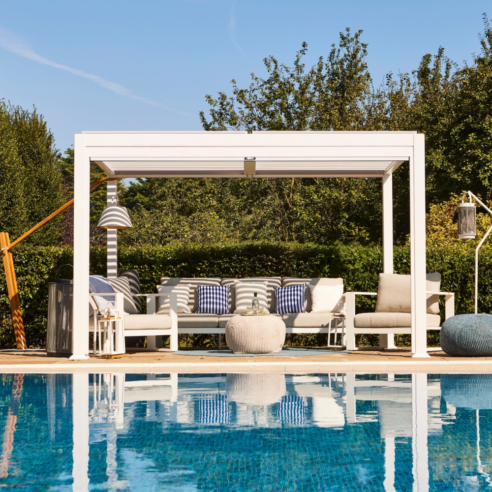 Suns Lifestyle Maranza Vented Pergola Lifestyle With Sofa White Daytime