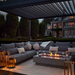 Suns Lifestyle Rota Louvered Pergola Lifestyle With Sofa and Fire Pit Table