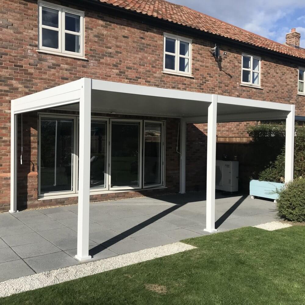 White pergola attached to house